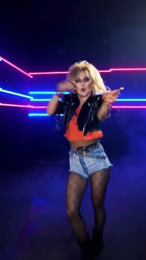 AI Video from prompt: The girl is singing and dancing to techno music,