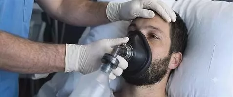 AI Video from prompt: The patient takes deep breaths into the anesthes