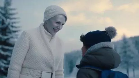AI Video from prompt: A charming sixty-year-old snow queen with a silv