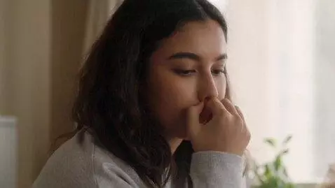 AI Video from prompt: A young woman picking her nostril