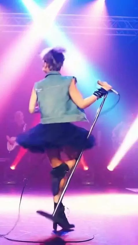 AI Video from prompt: A singer in a short tutu skirt is singing and do