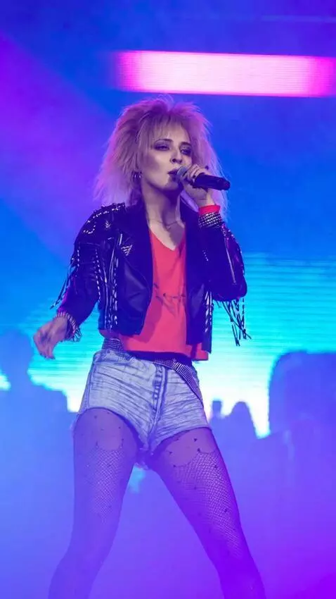 AI Video from prompt: The singer performs on stage, dances techno, and