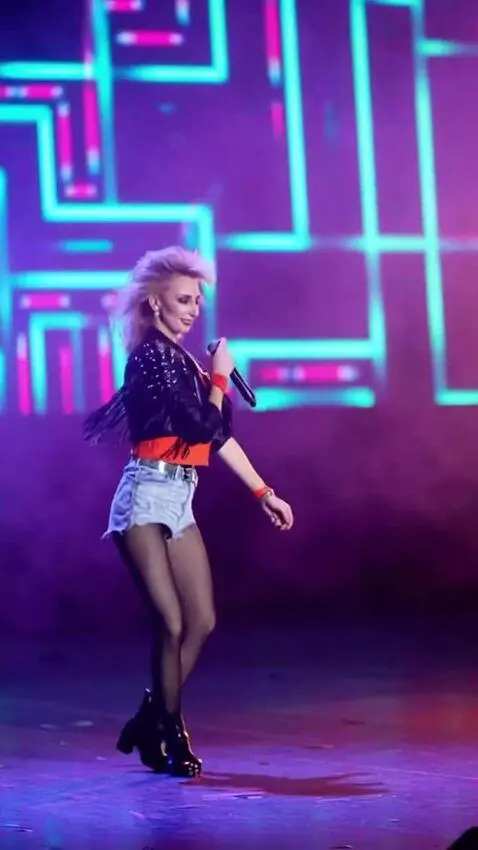 AI Video from prompt: The singer performs on stage, dances techno, and