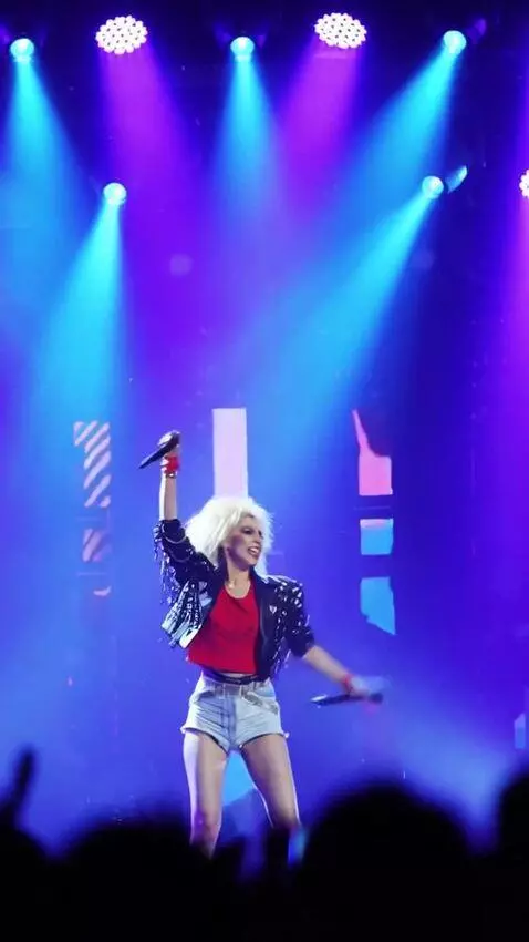 AI Video from prompt: The singer performs on stage, dances techno, and