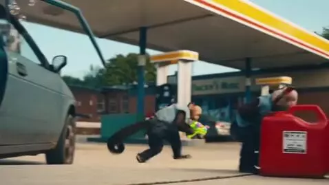 AI Video from prompt: Two monkeys arrive at a gas station with a toy b