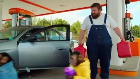 AI Video from prompt: Two monkeys arrive at a gas station with a toy b