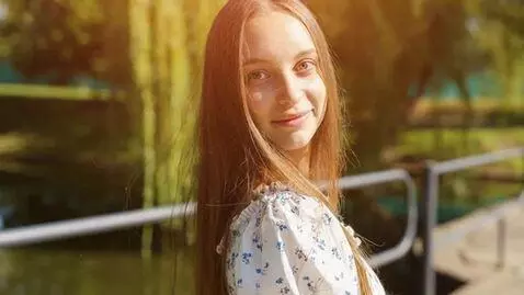 AI Video from prompt: A barefoot girl with messy hair, wearing a simpl