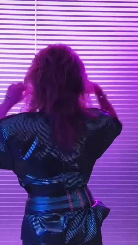 AI Video from prompt: Sandra moves to techno music, turns around, and 