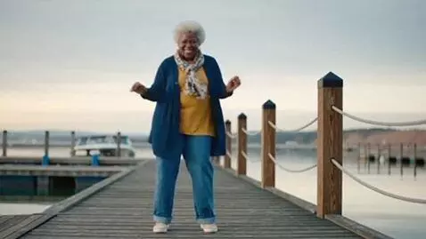 AI Video from prompt: black grandma happilly dancing with her docks