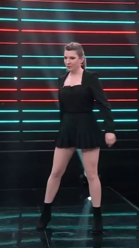 AI Video from prompt: The girl in a short skirt is moving to techno mu