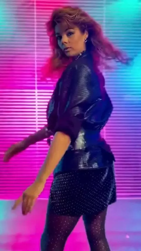 AI Video from prompt: A girl in the short skirt is moving to techno mu