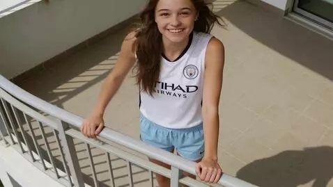 AI Video from prompt: the girl is looking at the camera. she waves her