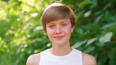 AI Video from prompt: A young woman posing for the camera with a subtl