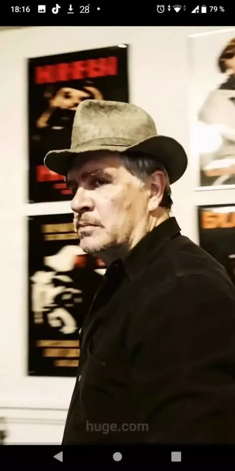 AI Video from prompt: The man puts on a wide dark coat and goes outsid