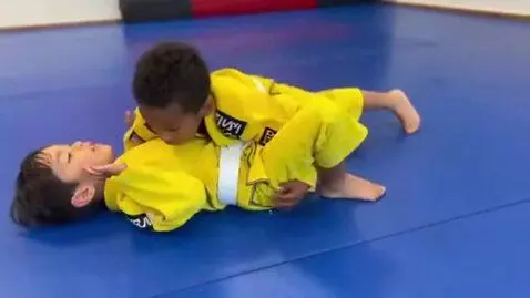 AI Video from prompt: two boys at six years,wearing yellow bjj jackets