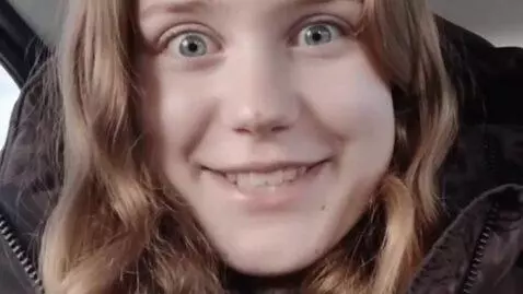 AI Video from prompt: Make her pull a funny face then she says “WHATS 
