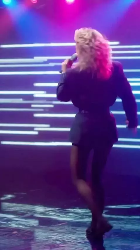 AI Video from prompt: The girl in the mini‑skirt is singing and doing 