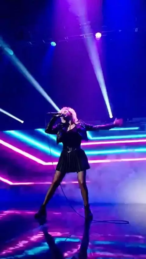 AI Video from prompt: A girl in a short skirt is singing and dancing t