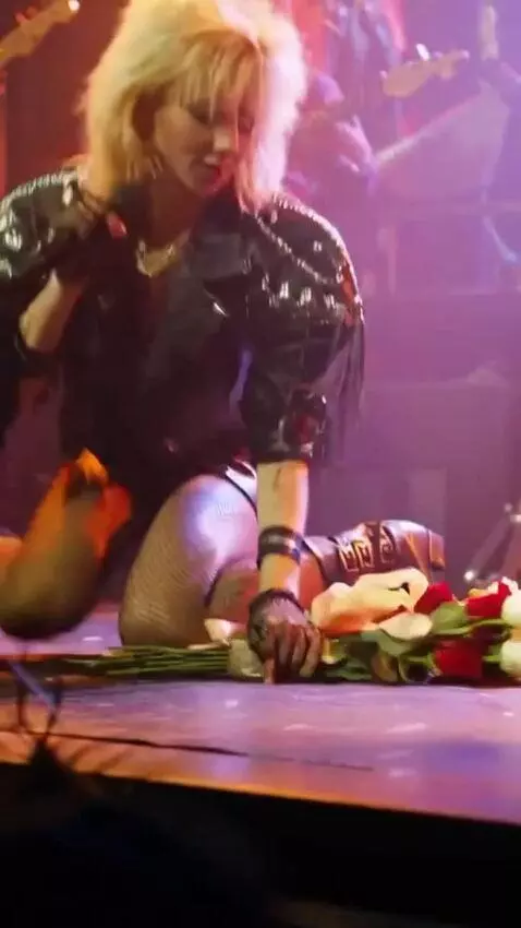 AI Video from prompt: The uninhibited singer in a mini skirt gets down