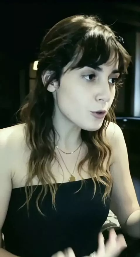 AI Video from prompt: A woman talks on a smartphone in front of a fire