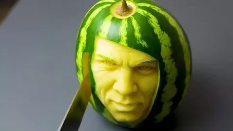 AI Video from prompt: A hand slowly carves a watermelon with a knife, 