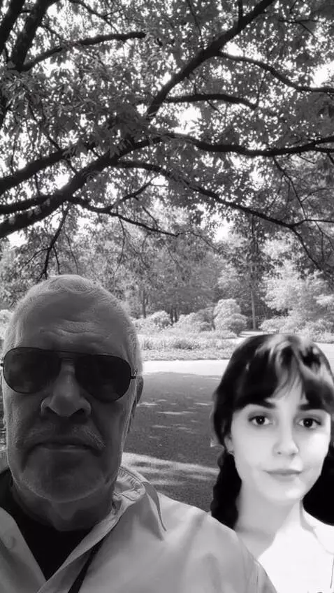 AI Video from prompt: A man and a woman listen to a street musician pl