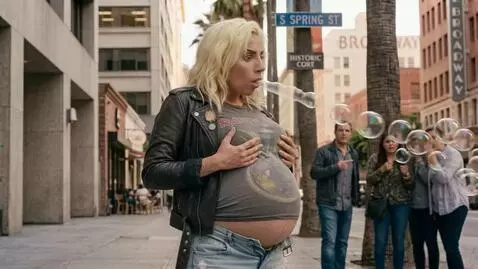 AI Video from prompt: A blonde woman is standing in the street hiccupi