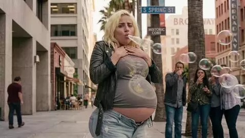AI Video from prompt: A blonde woman is standing in the street hiccupi