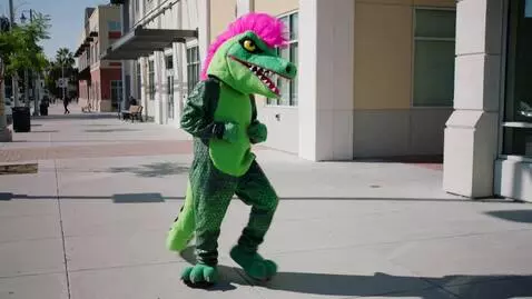 AI Video from prompt: A person inside the lizard mascot costume perfor
