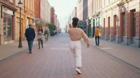 AI Video from prompt: a lady is dancing in the street and people walki