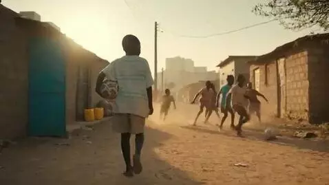 AI Video from prompt: A 9-year-old African boy named Mbemba walks bare