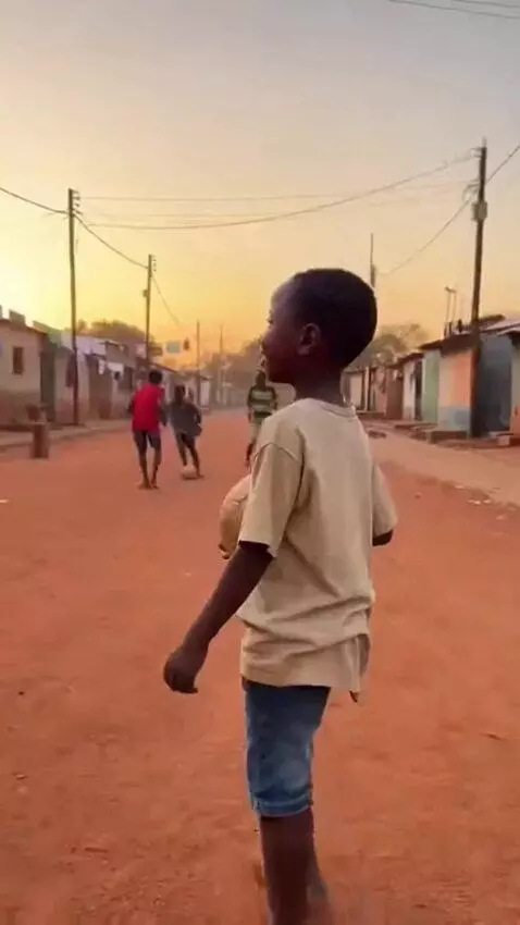 AI Video from prompt: A 9-year-old African boy named Mbemba walks bare