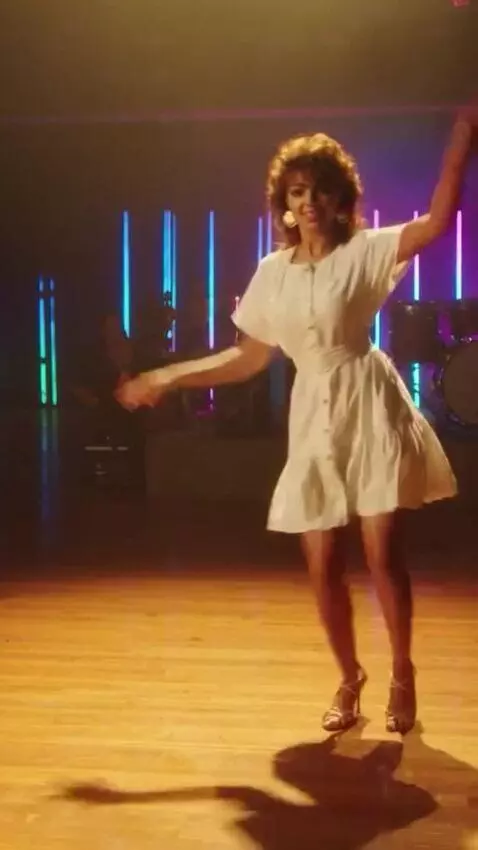 AI Video from prompt: Sandra is on stage in a short summer dress, danc