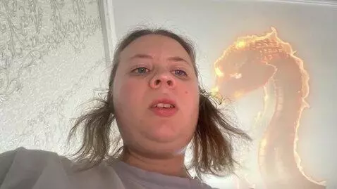 AI Video from prompt: I am Madina transforming into the fire serpent f