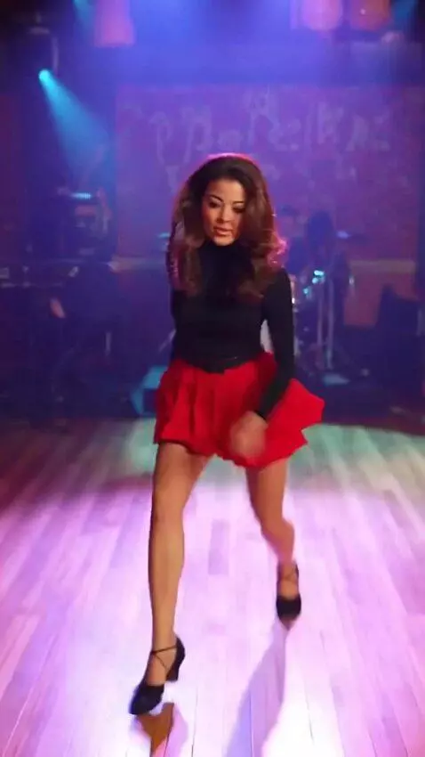 AI Video from prompt: Sandra is on stage in a short skirt, dancing the