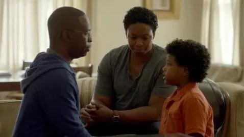 AI Video from prompt: A Haitian family is sitting together in the livi