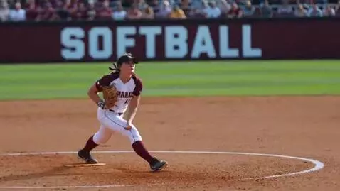 AI Video from prompt: A female softball player throws a pitch and sudd