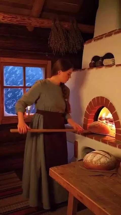 AI Video from prompt: In a log house, a girl is baking homemade bread 