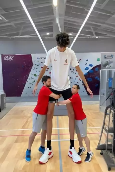 AI Video from prompt: Tallest boy huge each other with the little man 