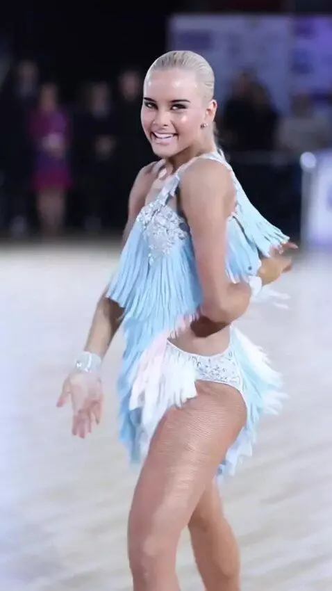 AI Video from prompt: The singer dances the jive, leaning forward, tur