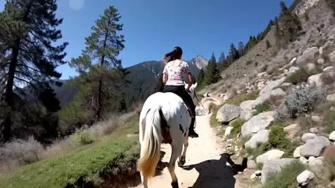 AI Video from prompt: A lady in floral print top and black pants ridin
