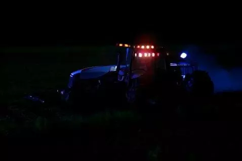 AI Video from prompt: Farm tractor working thin the farm fields in the