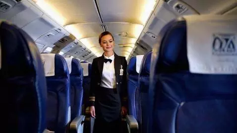 AI Video from prompt: Stewardess in a 60's style uniform walks toward 