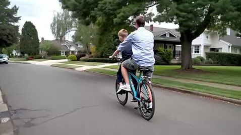 AI Video from prompt: A man and son riding bicycle in