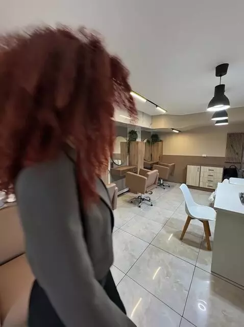 AI Video from prompt: A 25-year-old woman with voluminous curly red ha