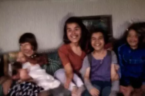 AI Video from prompt: 1980's VHS  family  home video everyone has a hu