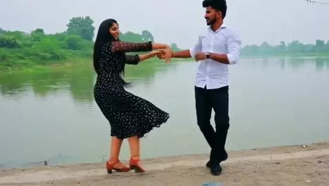 AI Video from prompt: Man and woman dancing by the river side
