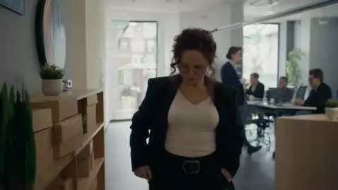 AI Video from prompt: a woman in an office break room. suddenly her bu