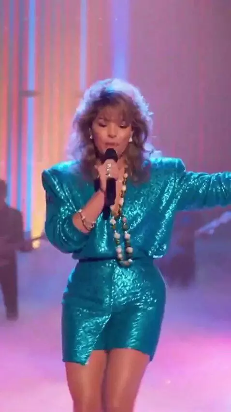 AI Video from prompt: Sandra is wearing a short dress, singing a song 