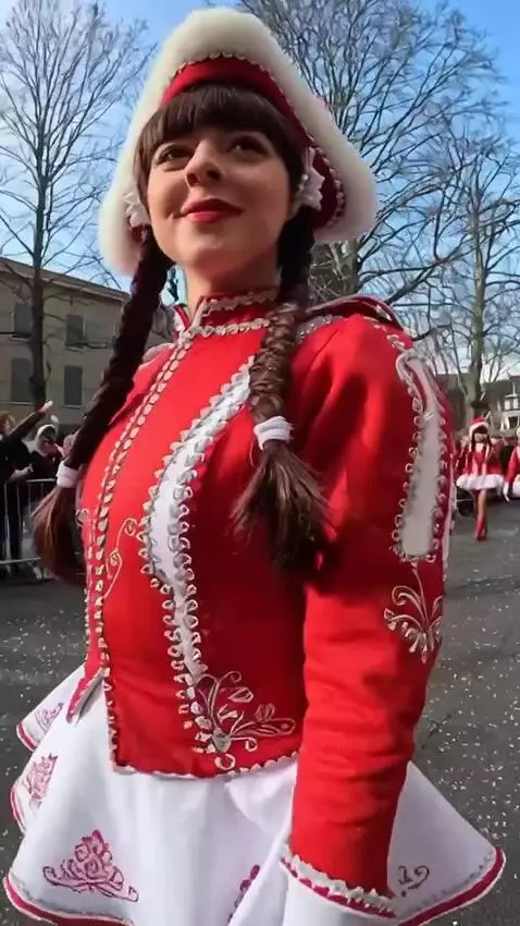 AI Video from prompt: The girl at the fiesta walks past us and looks a